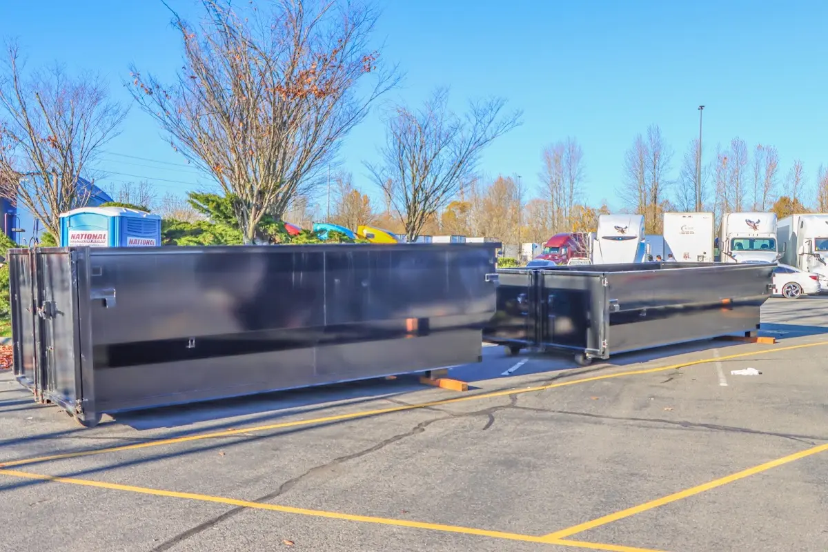 Professional dumpster rental service with roll-off container on residential driveway in Itasca